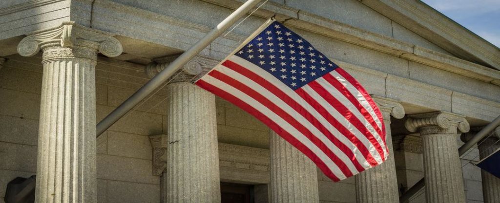 A courthouse waving an American flag